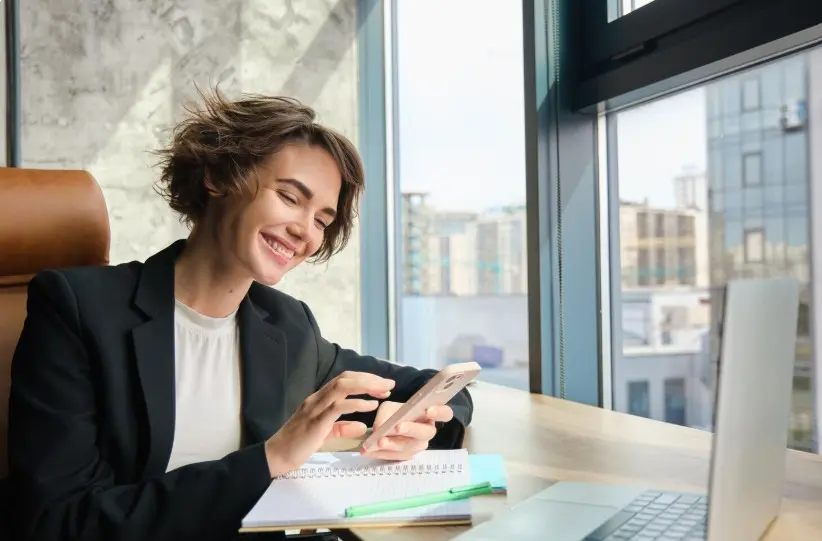 A happy woman using her phone