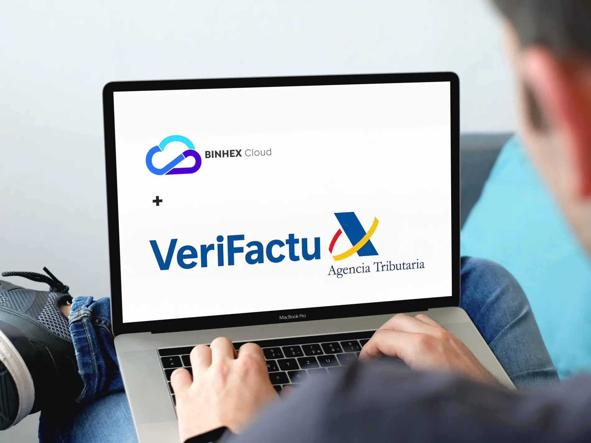 Person using laptop with Binhex cloud and verifactu logos